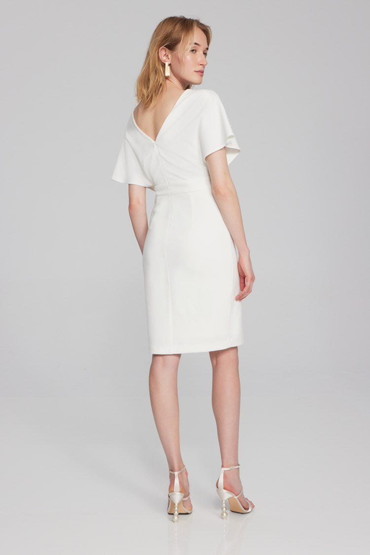 Joseph Ribkoff scuba crepe gown: trumpet skirt, ruffle, slit; wrap neckline, V-shaped back exude sophistication. Ideal for special occasions.