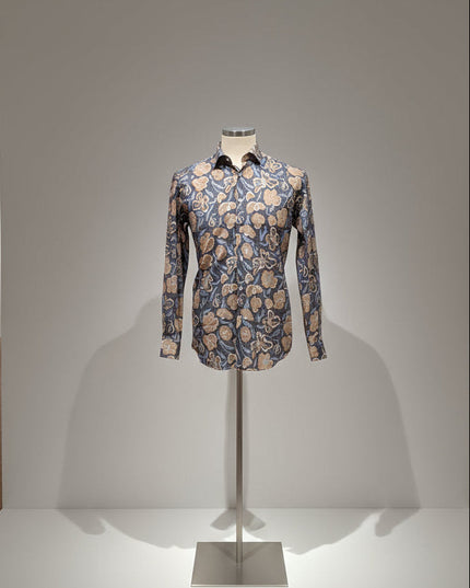 Floral patterned shirt on a mannequin against a plain background