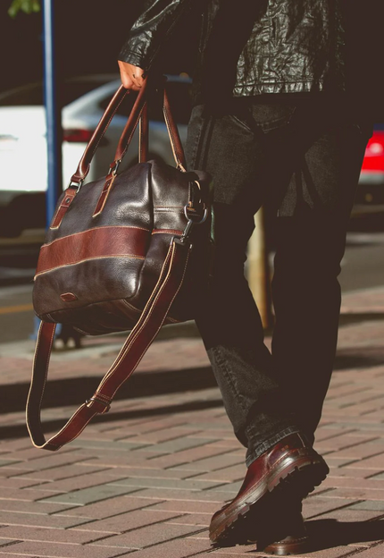 Vegetable-tanned leather duffle bag w/ handles and strap